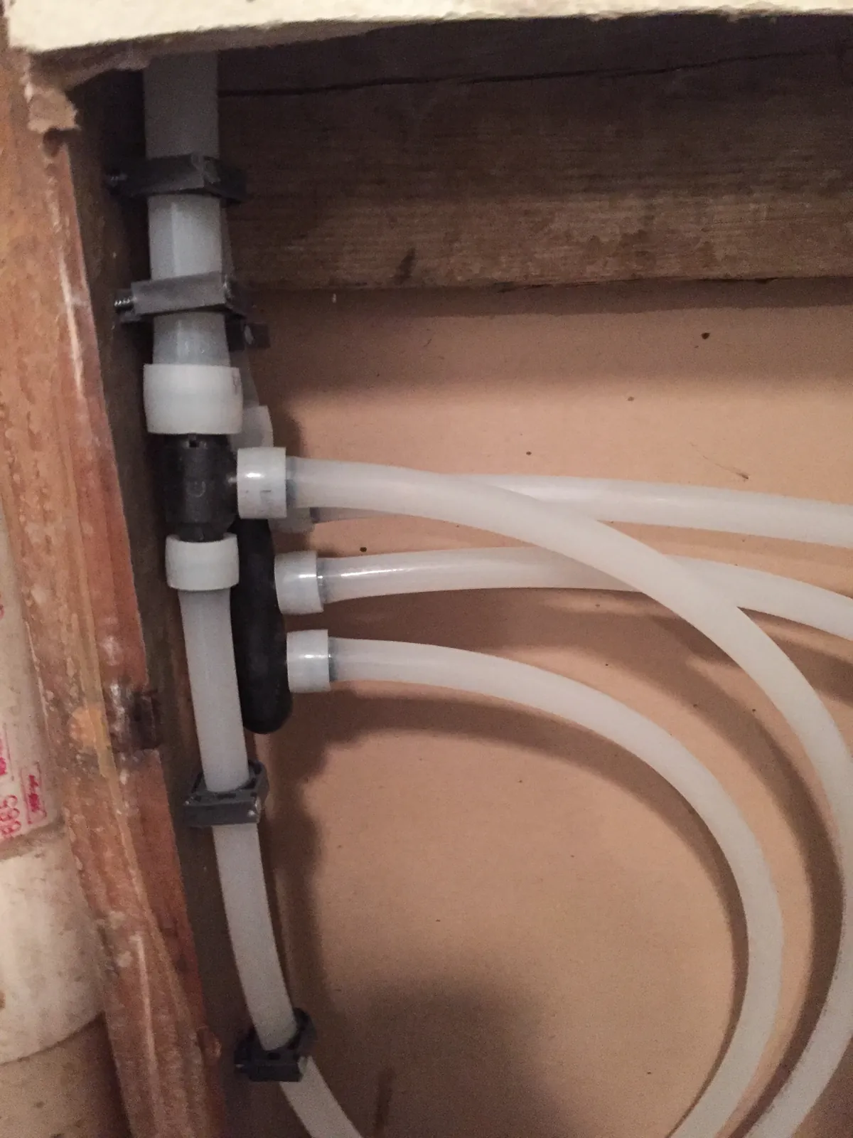 New white PEX supply lines routed through an open wall, from our San Juan Capistrano guide: Repiping an Older Home